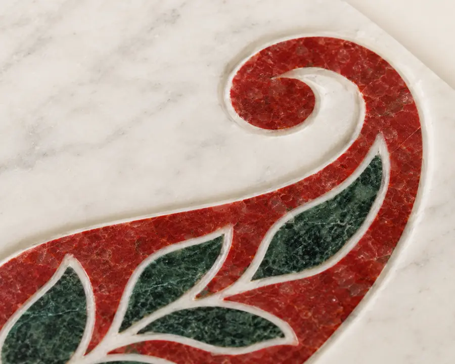 Paisley Corner Inlay Marble Panel — close view of the curling red inlay paisley tip